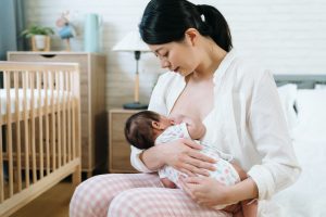 working mother on maternity leave breastfeeding